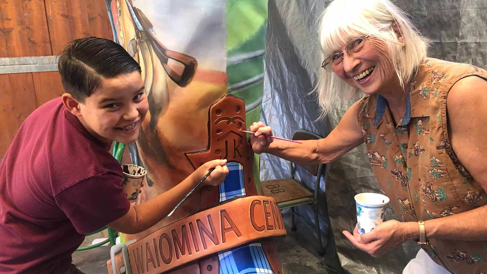 Ranch family members help repaint the Waiomina boot in Hawaii.