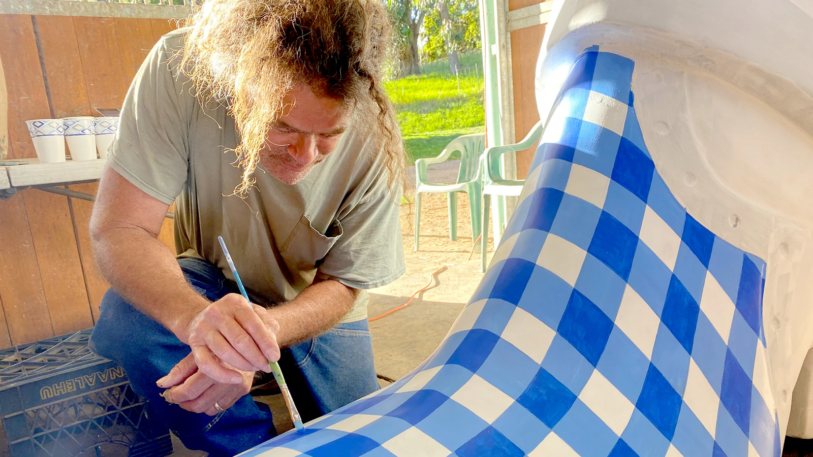 Tommy Mehau paints the Palaka pattern onto the Waiomina boot.