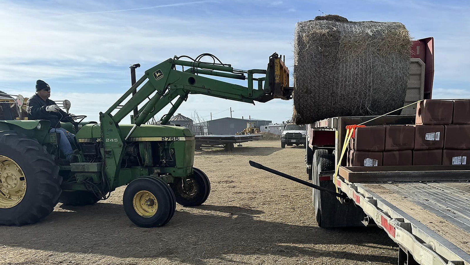 Leading up hay on a flatbed with a pallet of salt blocks.