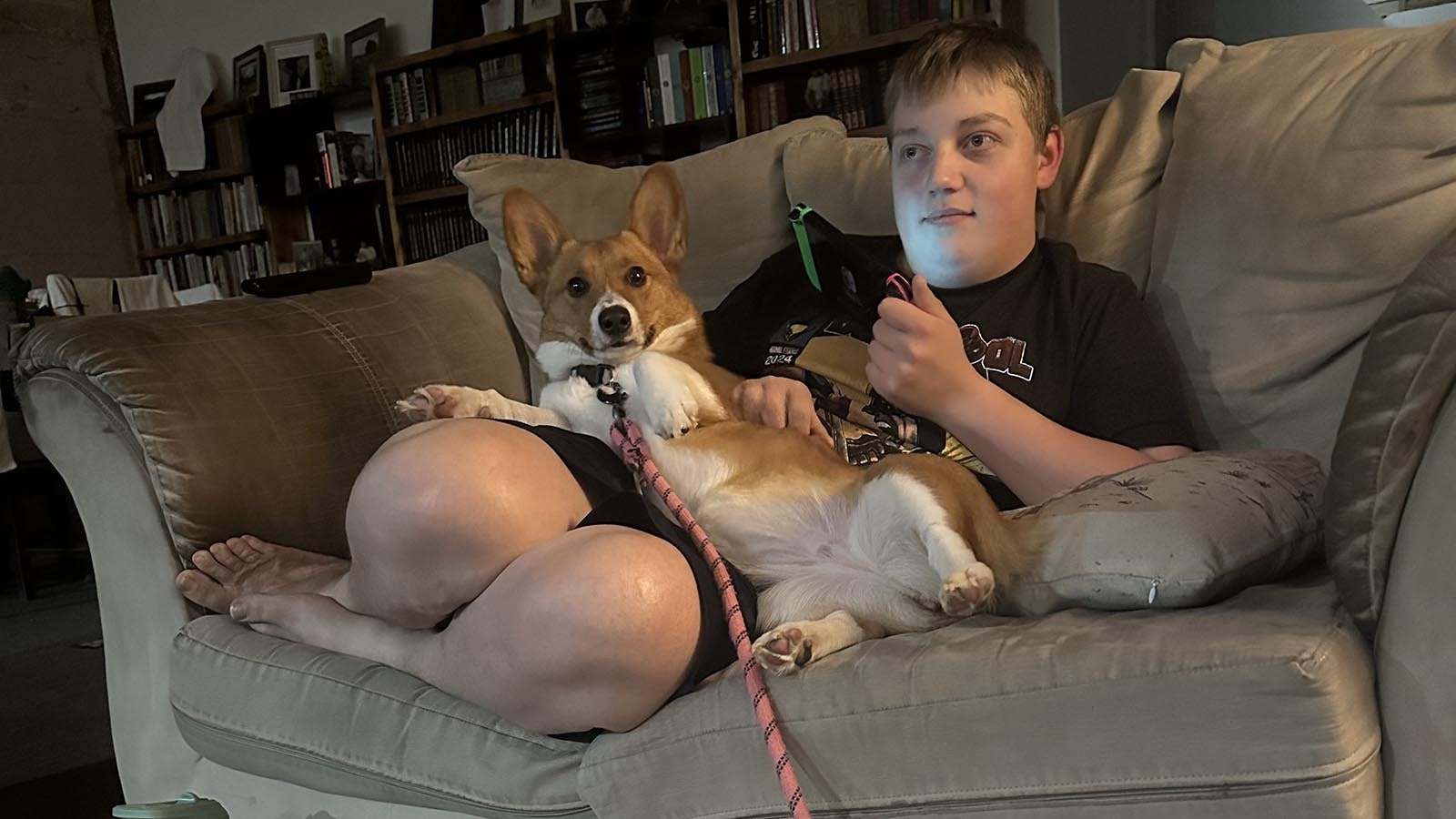 Ayden Skillman relaxes on the couch with the family dog while watching a movie.