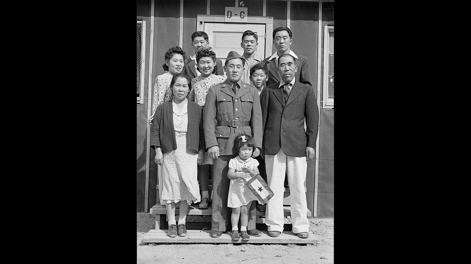 The Yamaro family, with their son home from the U.S. Army on leave, in front of their barracks in 1942.