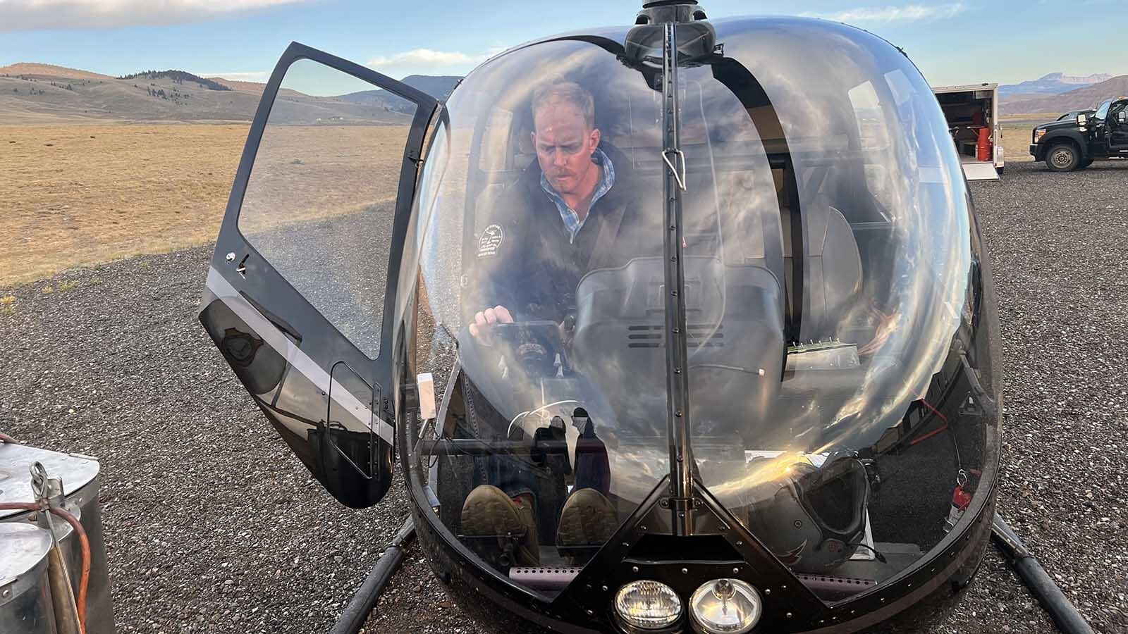 Pilot Emmett Webb of Rugged Mountain Aviation commercial helicopter services prepares to fire up a Robinson R66 helicopter at the Dubois Municipal Airport early Tuesday.