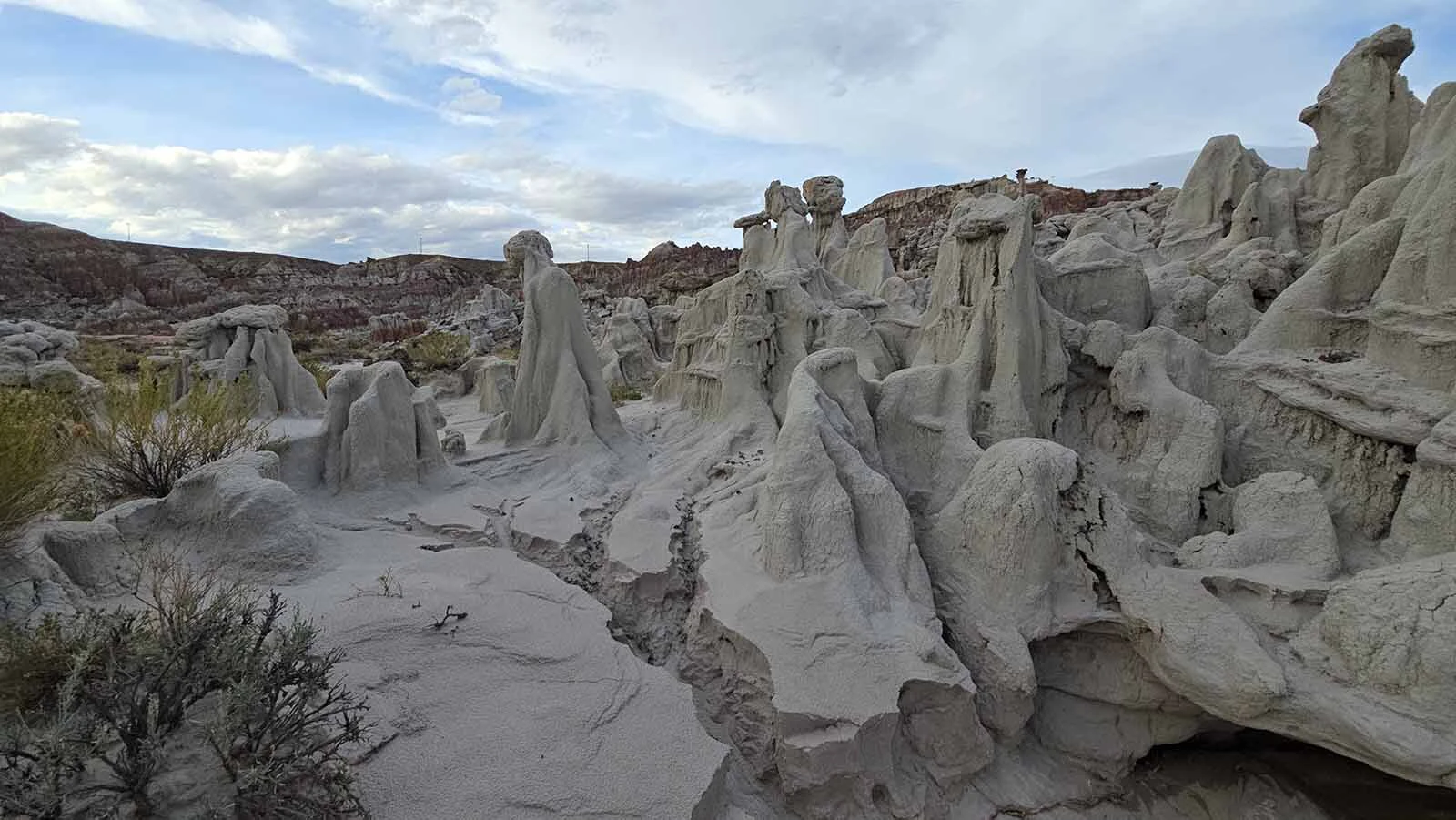 A rock formation at Hell's Half Acre that look like a group of twisted souls made from some sort of marble, writhing under a blue sky.