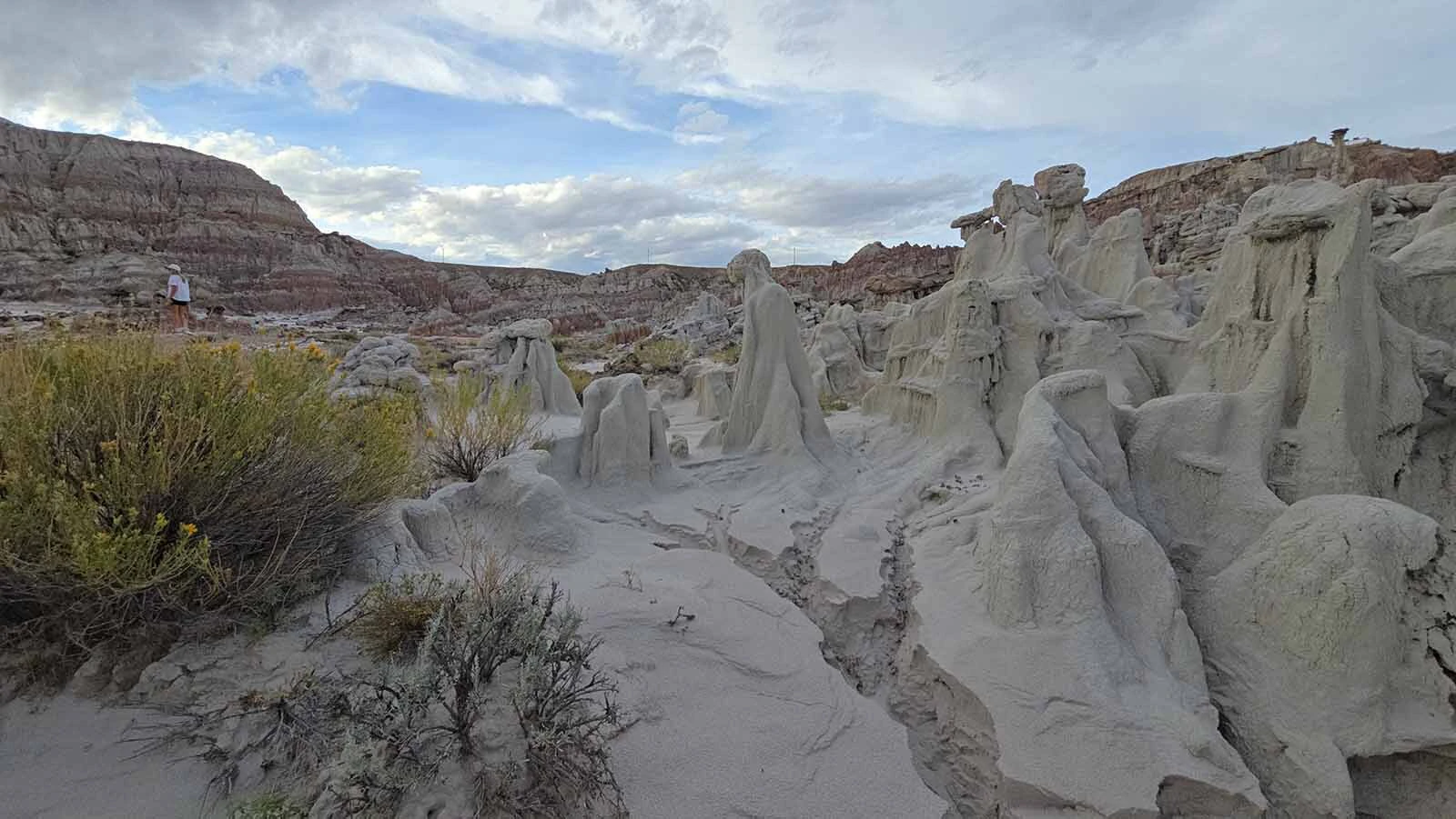 A rock formation at Hell's Half Acre that look like a group of twisted souls made from some sort of marble, writhing under a blue sky.
