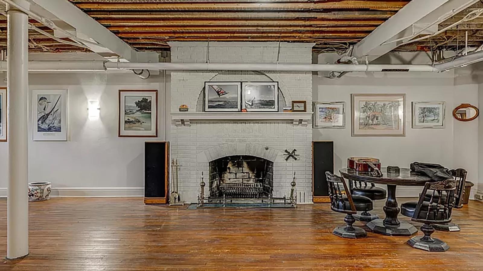 The basement area described as a “ballroom” in an article about the mansion’s construction in 1924 offers a wood floor, working wood fireplace, and an original poker table.