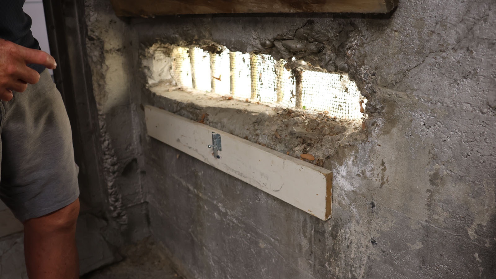 The boiler room off the basement features a steel door and a mysterious hand-made slotted hole in the wall with bars on it.