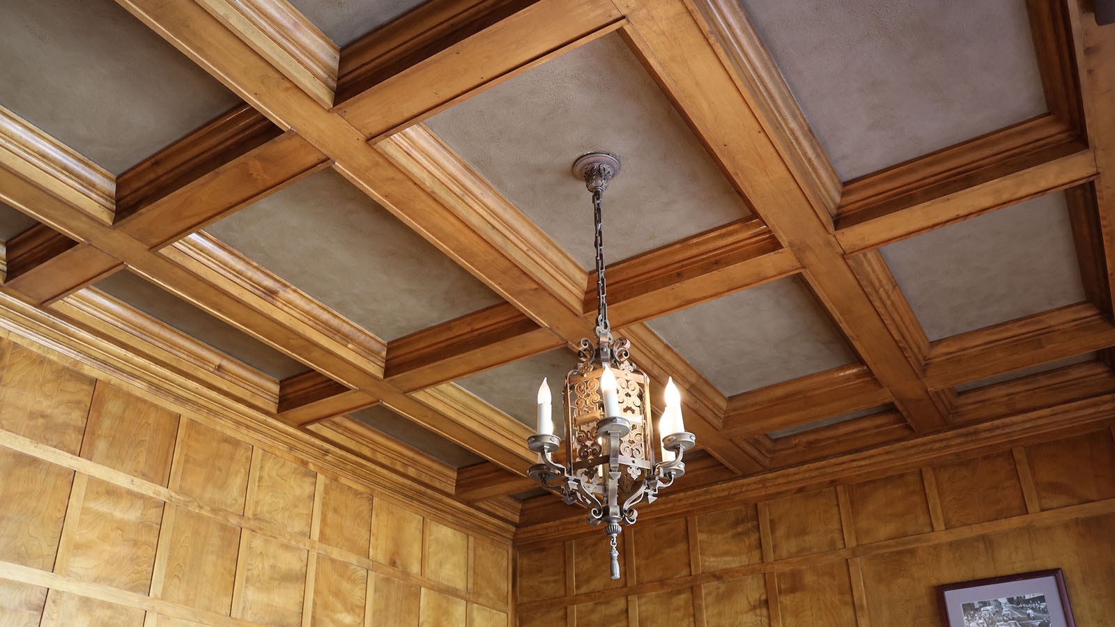 The ceiling in the office boasts woodwork and sheet rock textured and painted to look like leather.