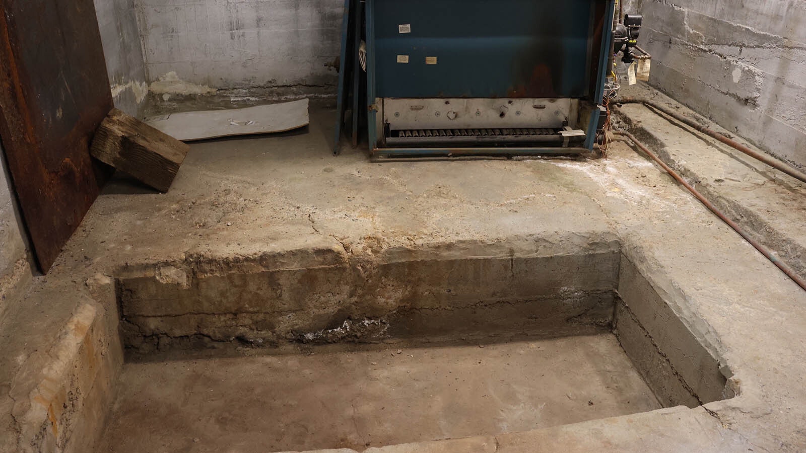 A pit in the floor of the boiler room raises suspicions about a possible tunnel in the past.