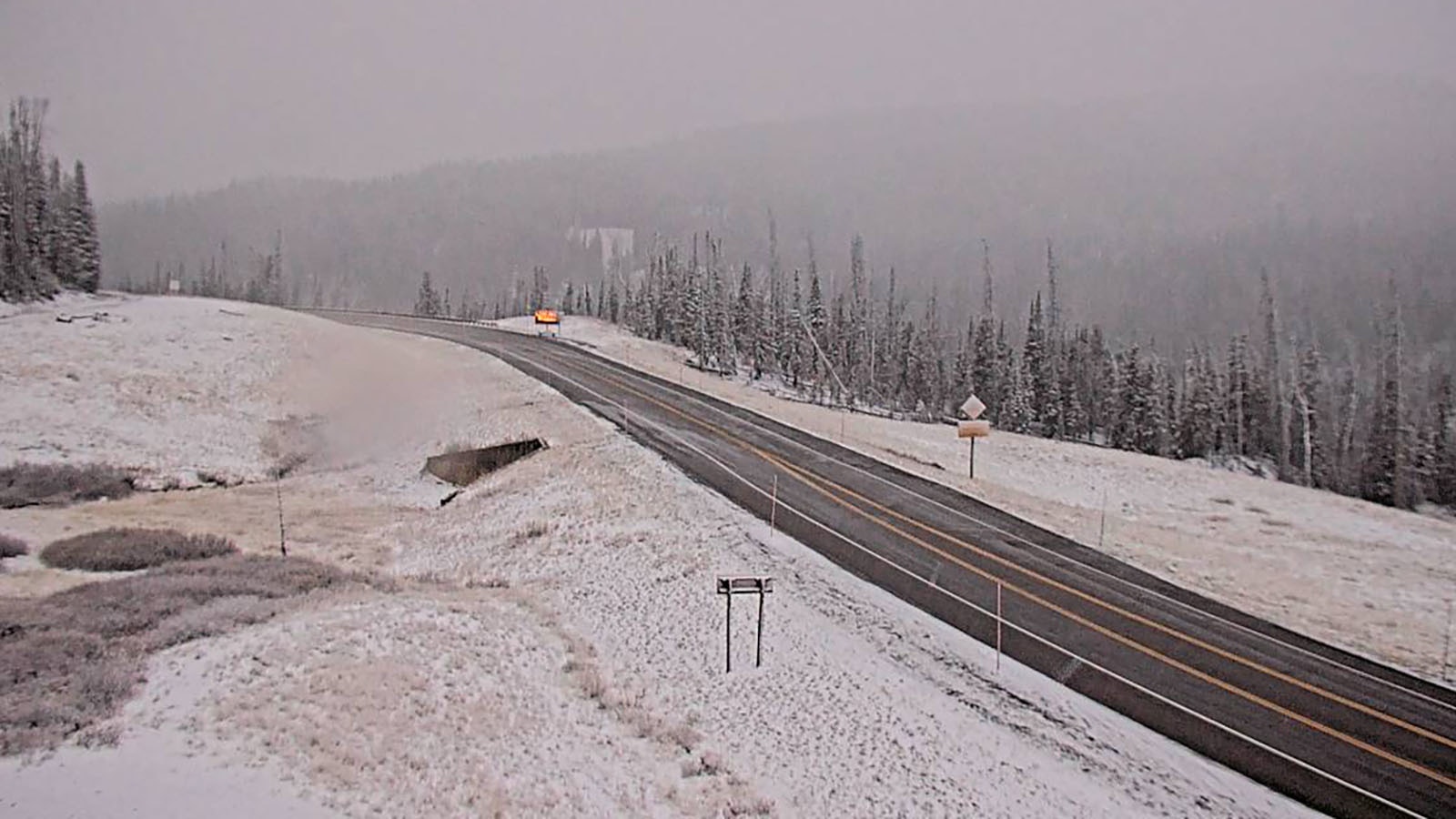 Snow is falling on the Pack Trail Fire and Togwotee Pass on Highway 26 west of Dubois in the Bridger-Teton National Forest.