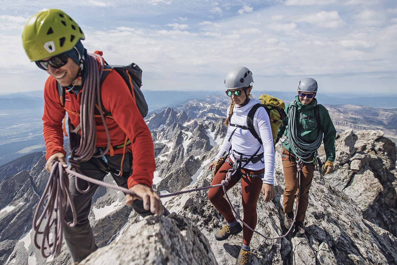A group of hikers and climbers summit a peak in the Grand Tetons of Wyoming.