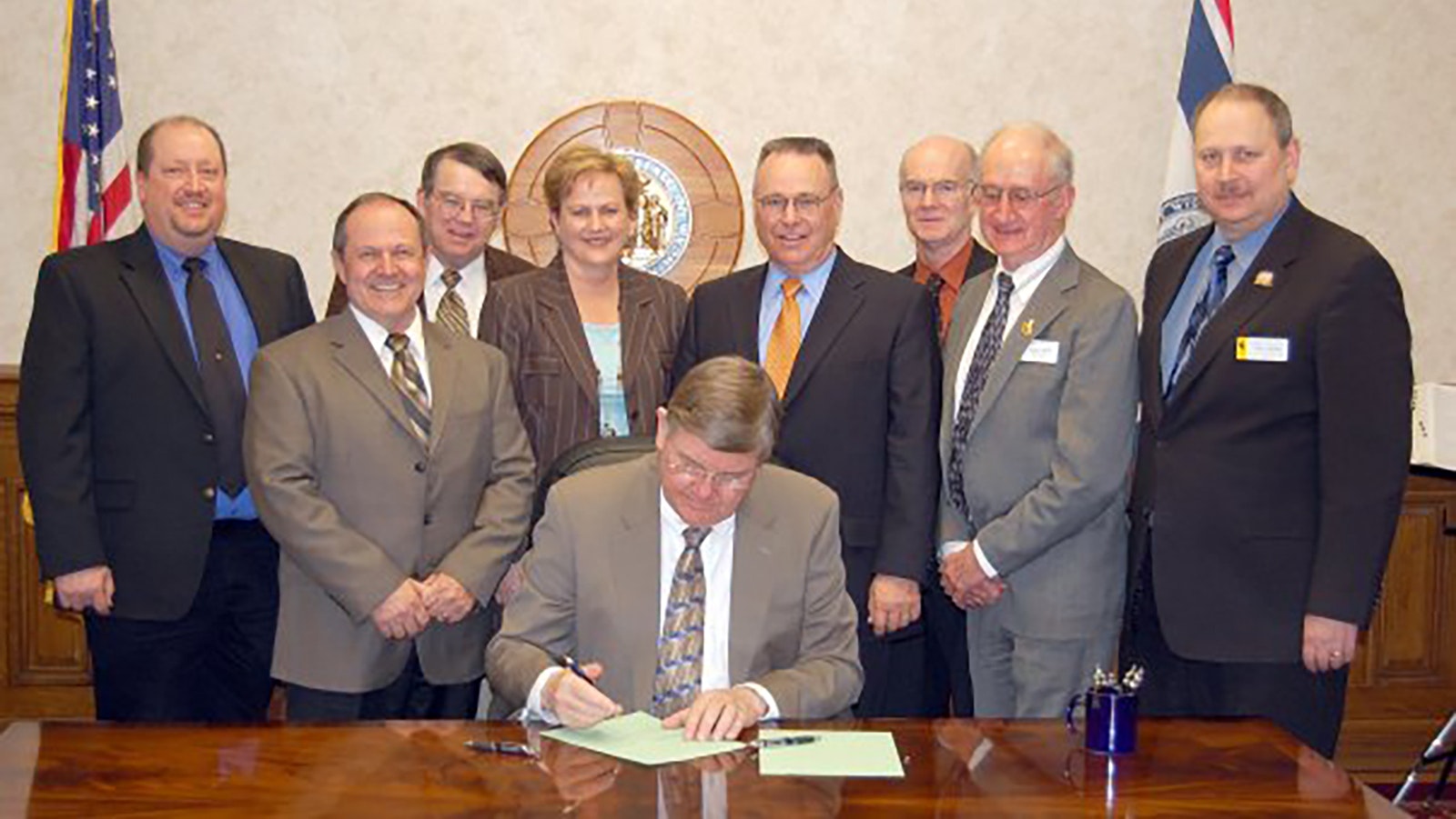 John Hines (second from right) watches as former Wyoming Gov. Dave Freudenthal signs into law a Madison Pipeline bill in 2009.