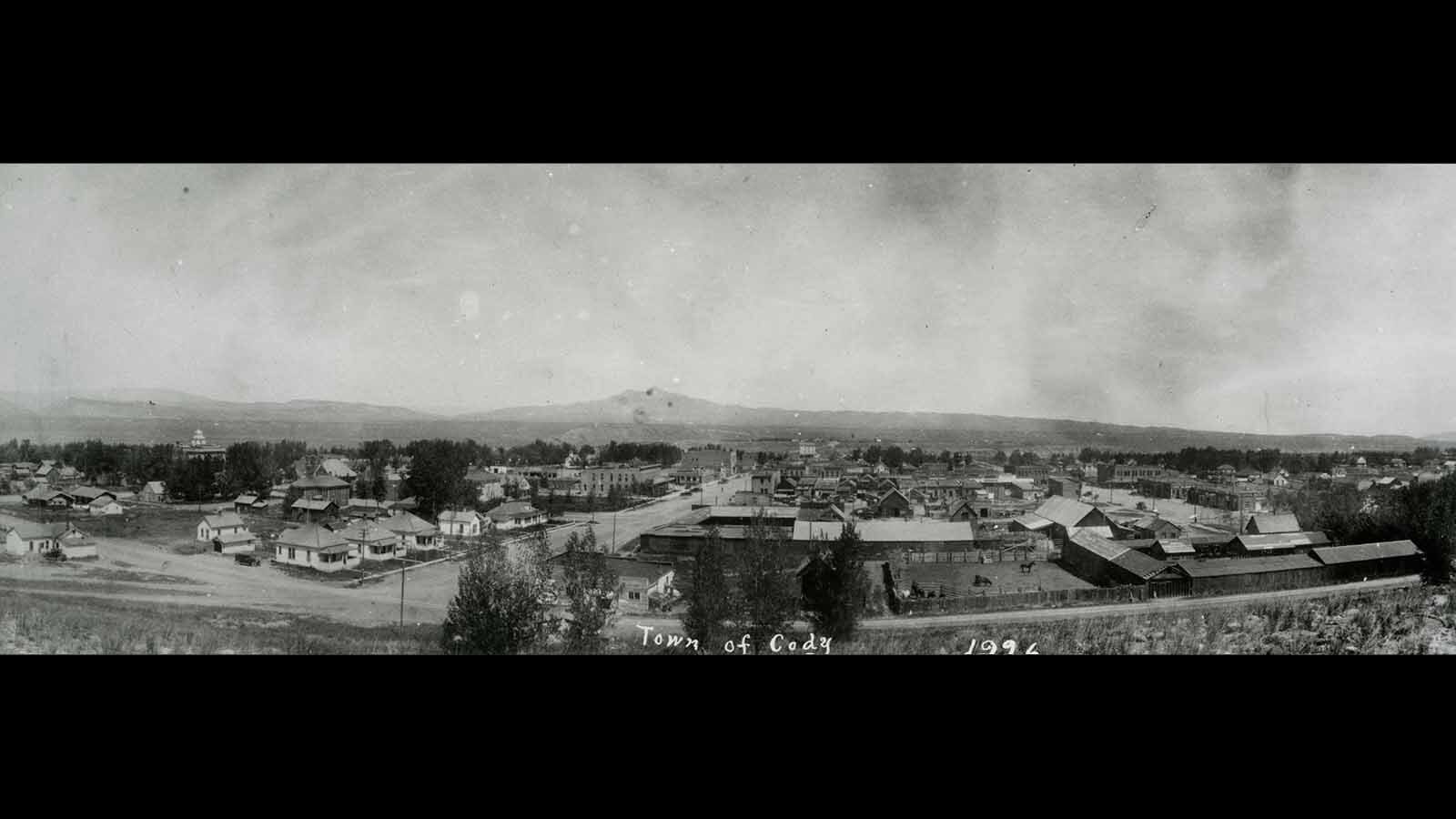 Panoramic view of Cody in 1926 taken from atop the bench on the south side of town looking north toward Heart Mountain. Alger Avenue is in the foreground and 12th Street center left. Visible buildings, from left, are: Park County Courthouse, Irma Hotel, Walls Building, Cody Flour Mill and the back of the Keystone Barn & Livery.