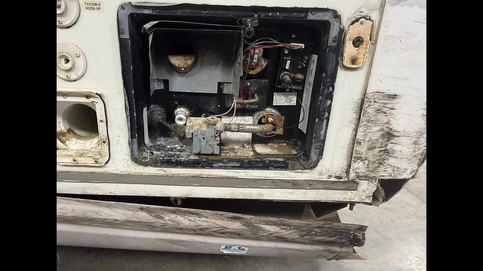 The hit-and-run damaged utility compartments and the lower side of the camper Rivers Tabb and his family call home.