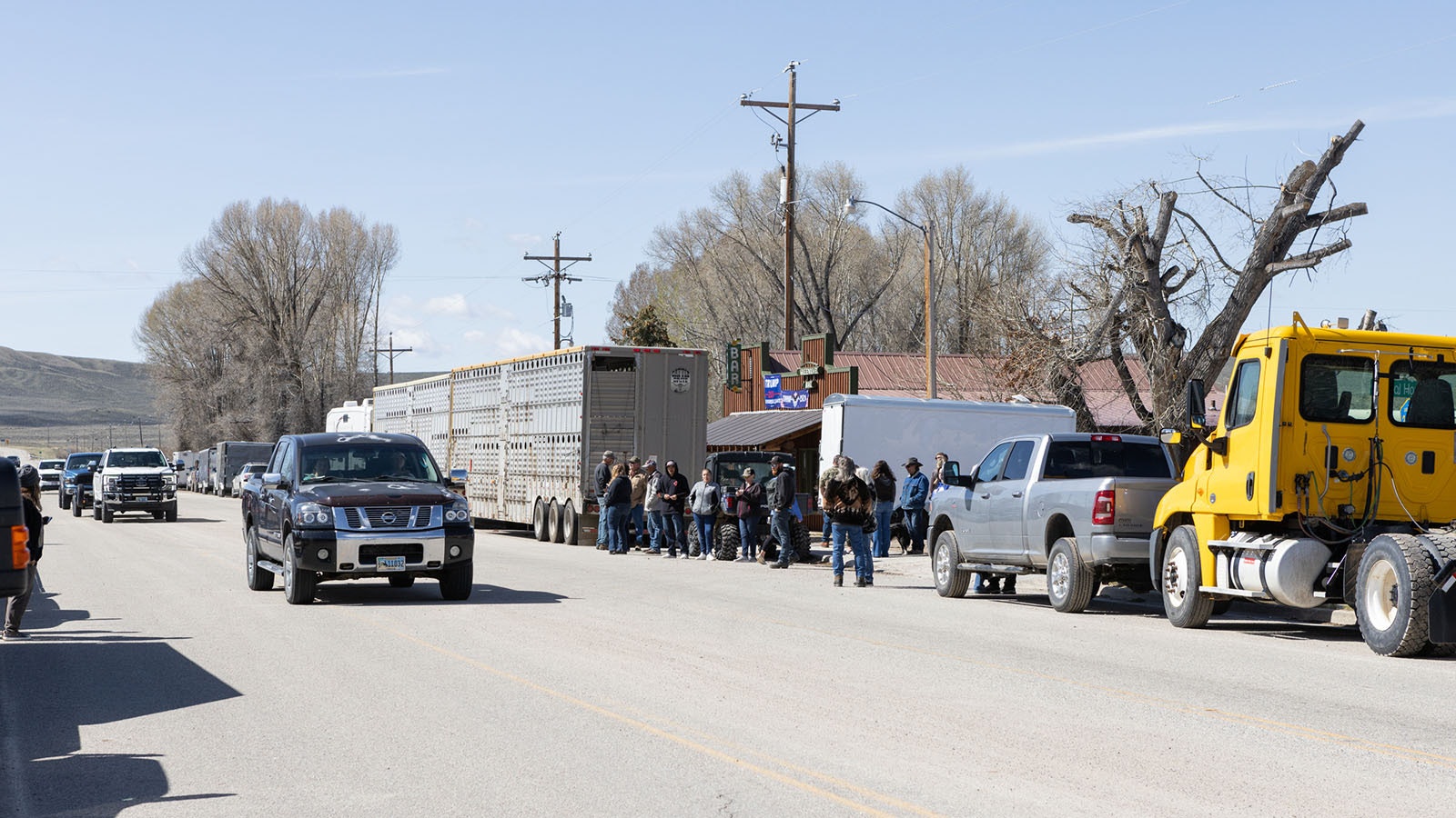 Cattle trailers and vehicles were parked in front of the Green River Bar in Daniel, Wyoming, for the Hogs For Hope motorcycle rally on May 26, 2024.
