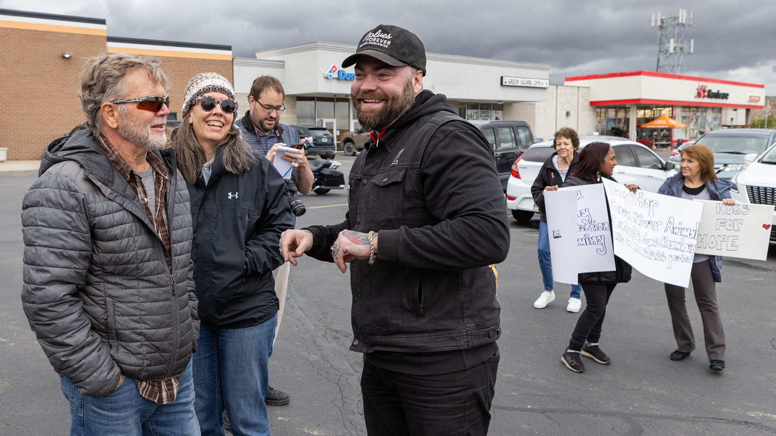 Jonas Black, organizer of the Hogs for Hope motorcycle rally, talks with rally supporters at the Flaming Gorge Harley-Davidson in Green River, Wyoming, on May 25, 2024.
