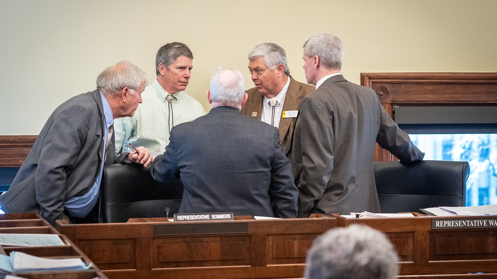 Members of the House Joint Conference Committee huddle during Tuesday's negotiations.