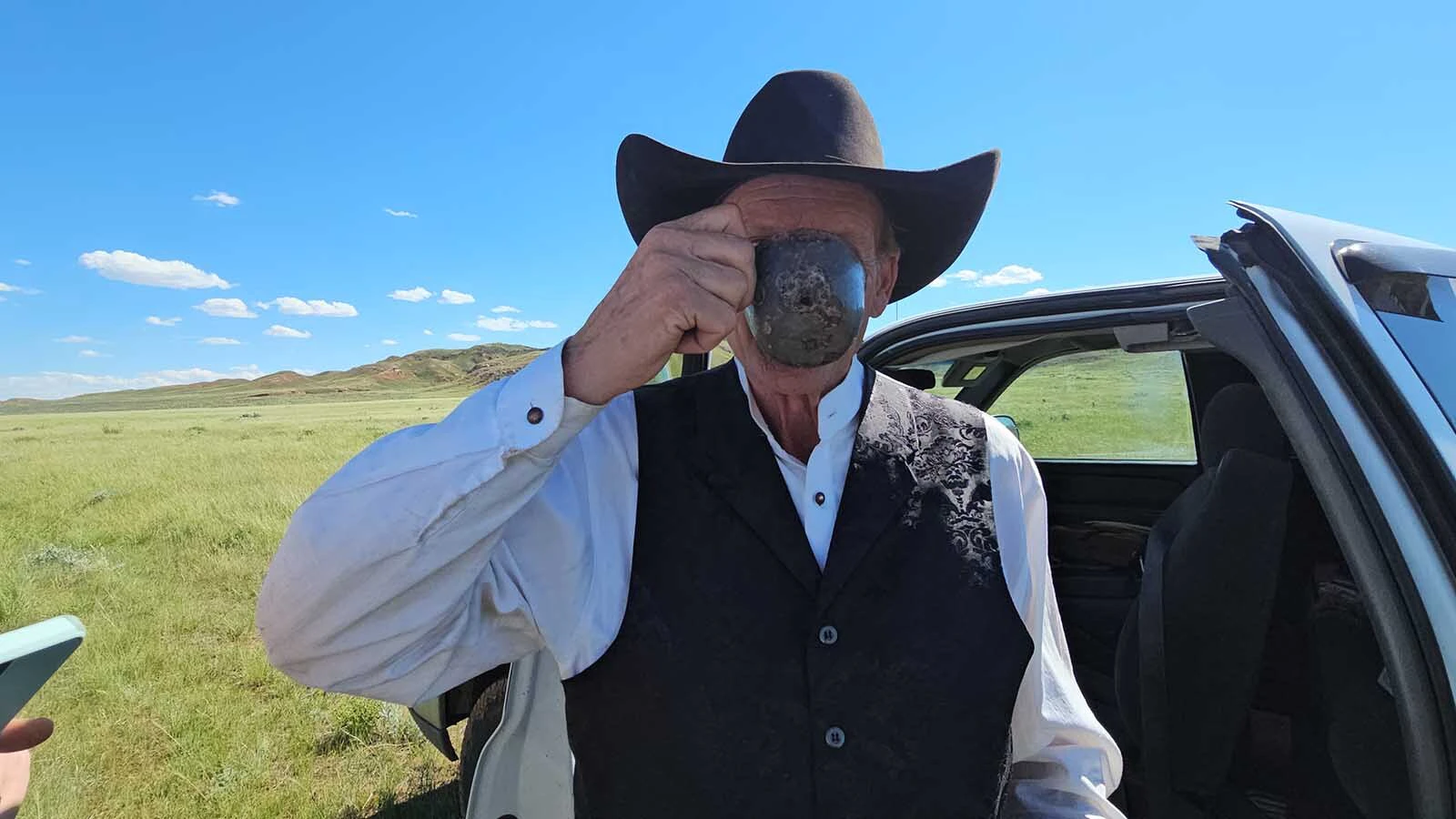 Clay Gibbons shows the tin cup he found in the Hole in the Wall Country with a single bullet-hole shot through it. Gibbons suspects that it points to an unsolved murder.