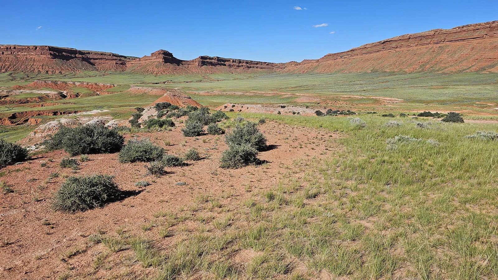 This red cliff wall runs for 35 miles straight, seemingly without a break. There is one notch, however, where a man can slip past and seemingly vanish.