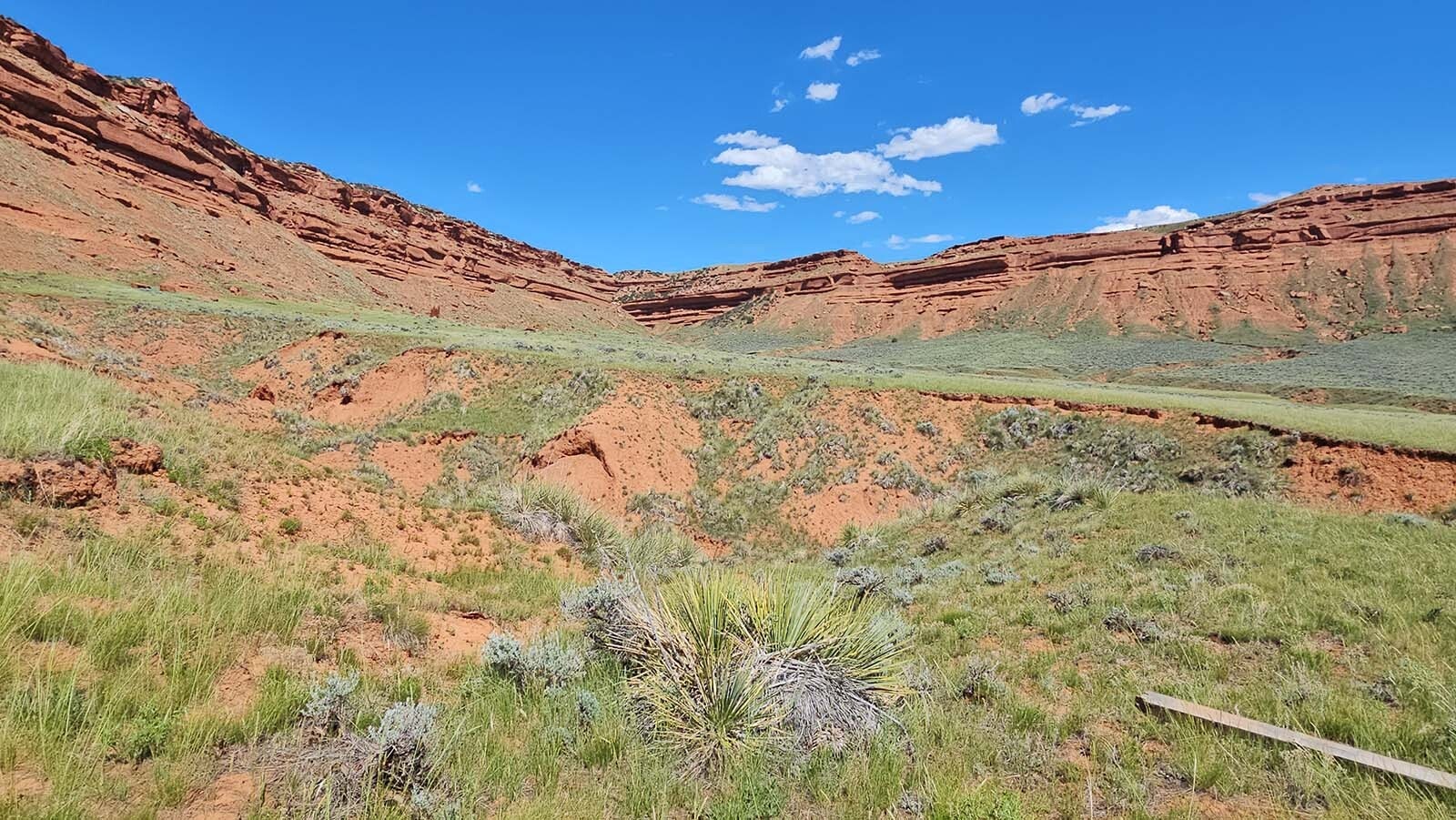The red Chugwater formation creates the walls of the Hole in the Wall hideout used by famous outlaws like Butch Cassidy and Jesse James in Johnson County, Wyoming. There is one narrow pass in the front where a person can slip behind the wall.