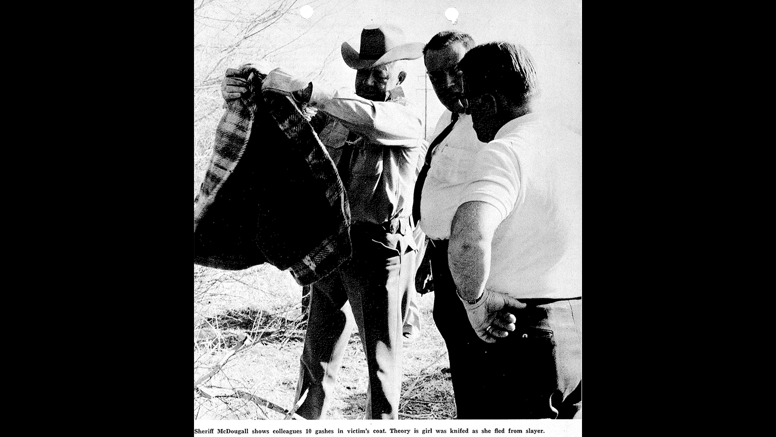 Fremont County Sheriff Pee Wee McDougall holds up Vicki Mather’s coat.