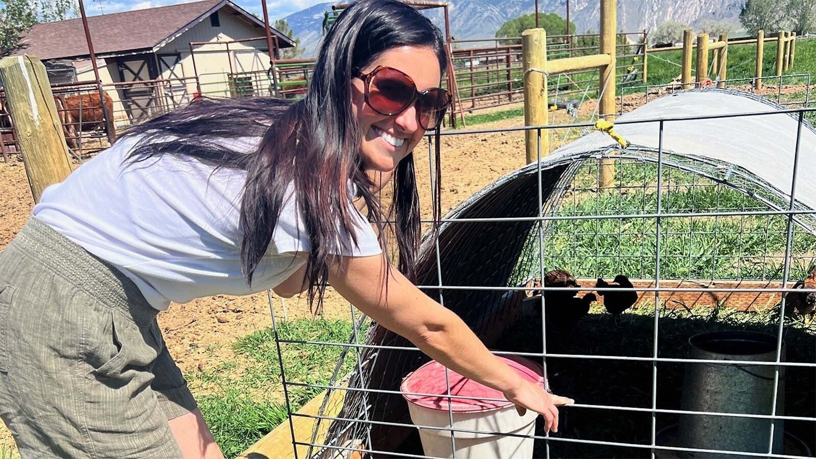 Ashley Trudo feeds the chickens.