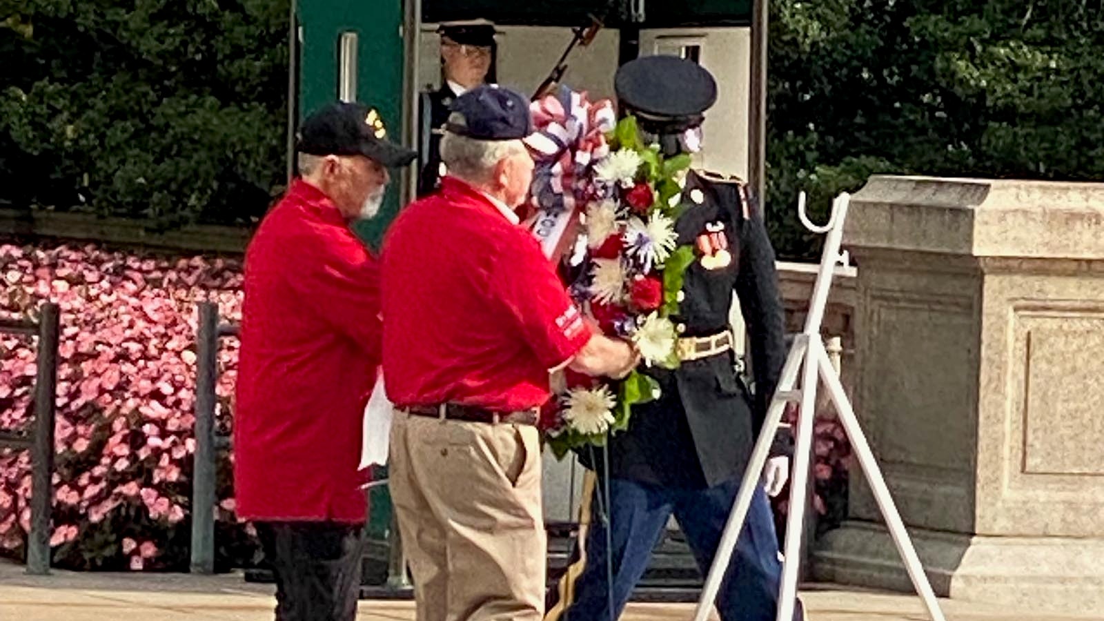 Members of the Rocky Mountain Honor Flight help lay a wreath at the Tomb of the Unknown Soldier at Arlington National Cemetery.