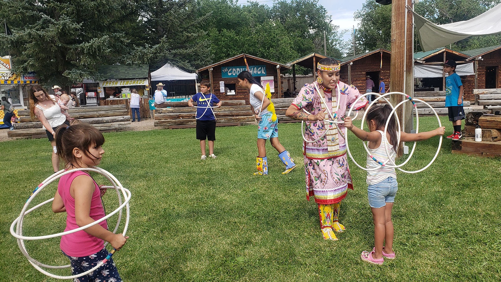 Zariah June Whiteplume teaches kids about hoop dancing at Cheyenne Frontier Days.