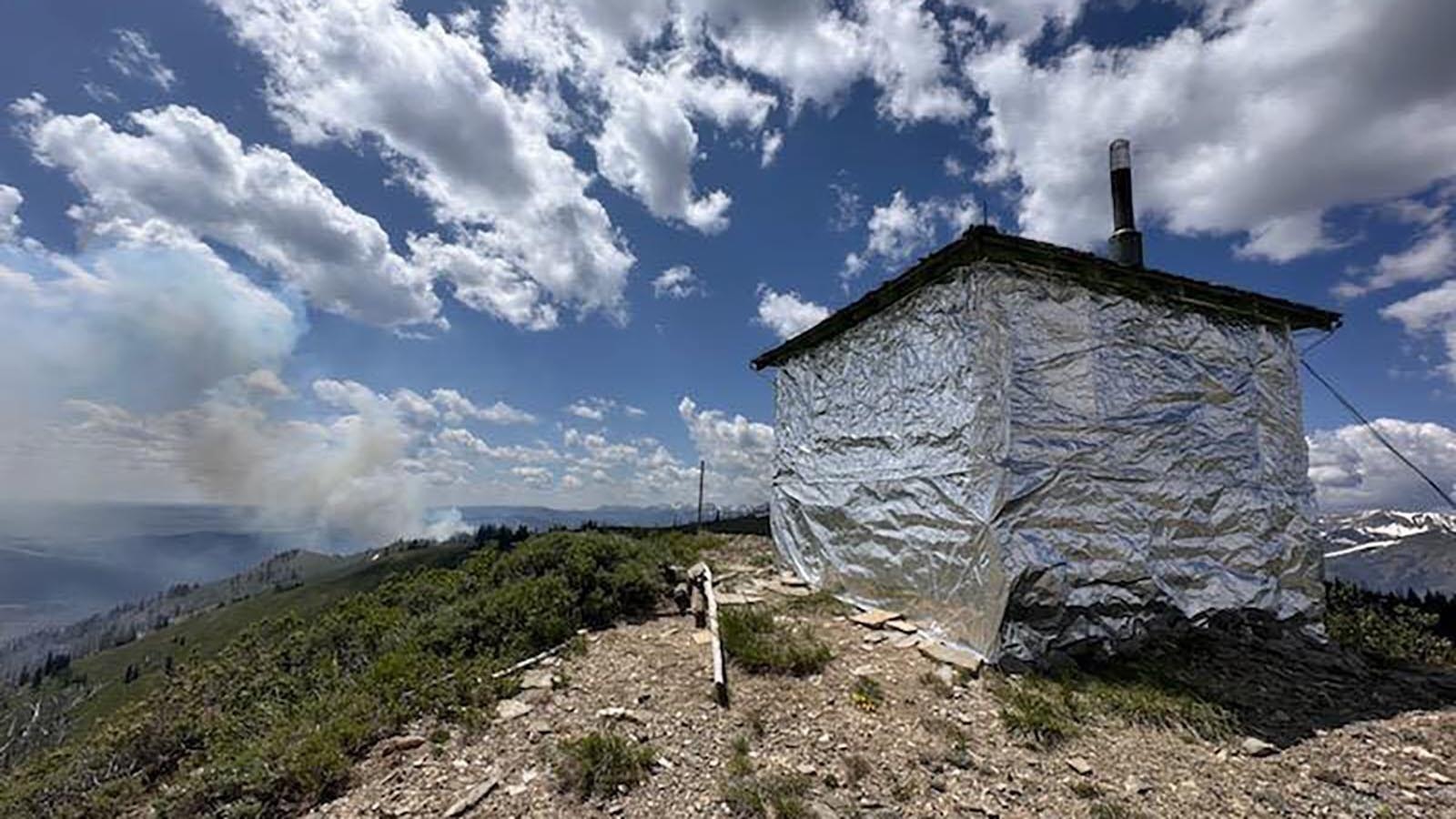 The Horse Fire burning in the Bridger-Teton National Forest on Tuesday has come within 2 miles of a historic fire lookout post on Prospect Peak. The outpost has been covered in an aluminum-based wrap as a precaution.