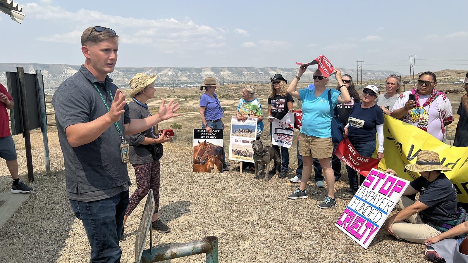 Bureau of Land Management spokesman James Fisher speaks to people who came to Rock Springs on Monday to protest the BLM’s roundup of mustangs.