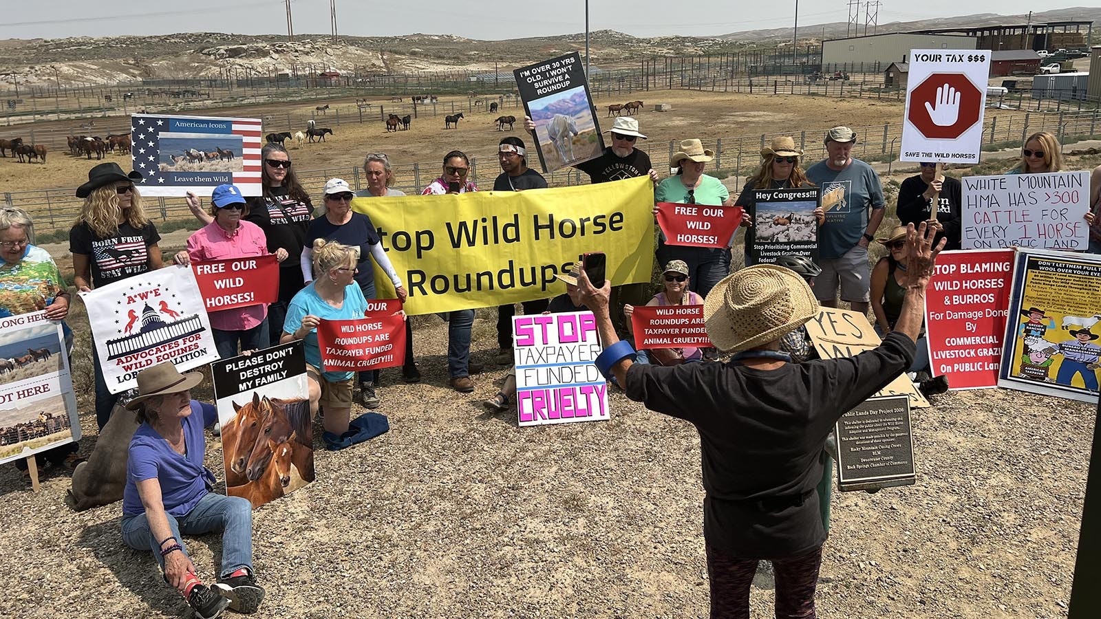 Wild Horse advocate Gail Bumsted addresses protestors overlooking the Bureau of Land Management mustang holding corrals just north of Rock Springs on Monday.