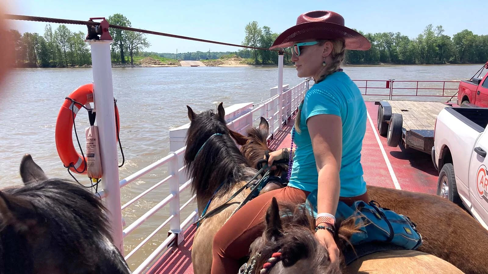 When Lisanne Fear sat down to write a suicide note, she couldn't bring herself to part with a mustang named Phineas. That decision led to the Pinedale, Wyoming, woman's 5,000-mile ride across the U.S. Above, she rides on an Illinois ferry.