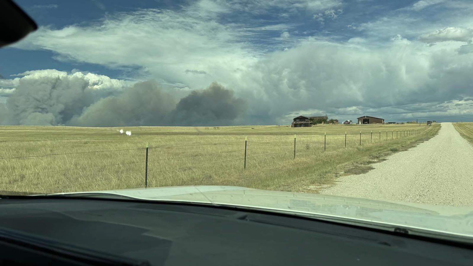 Huge plumes of smoke from the House Creek Fire as it burns past the home of Ashley Malcom near Buffalo, Wyoming. Malcom said the fire moved fast, but thankfully missed her property.