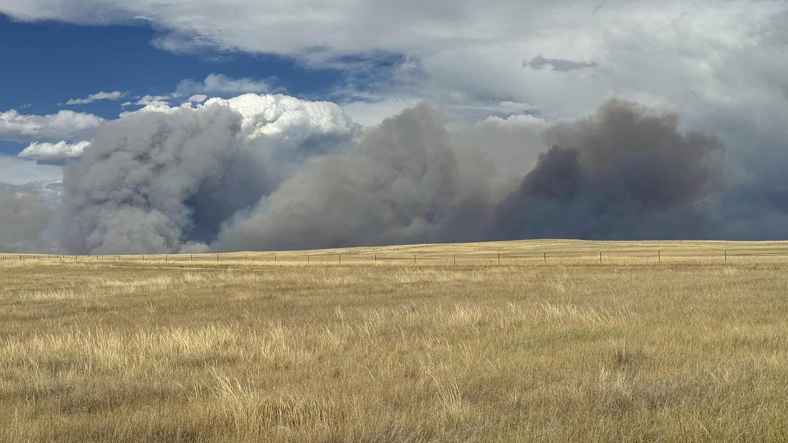 Huge plumes of smoke from the House Creek Fire as it burns past the home of Ashley Malcom near Buffalo, Wyoming. Malcom said the fire moved fast, but thankfully missed her property.