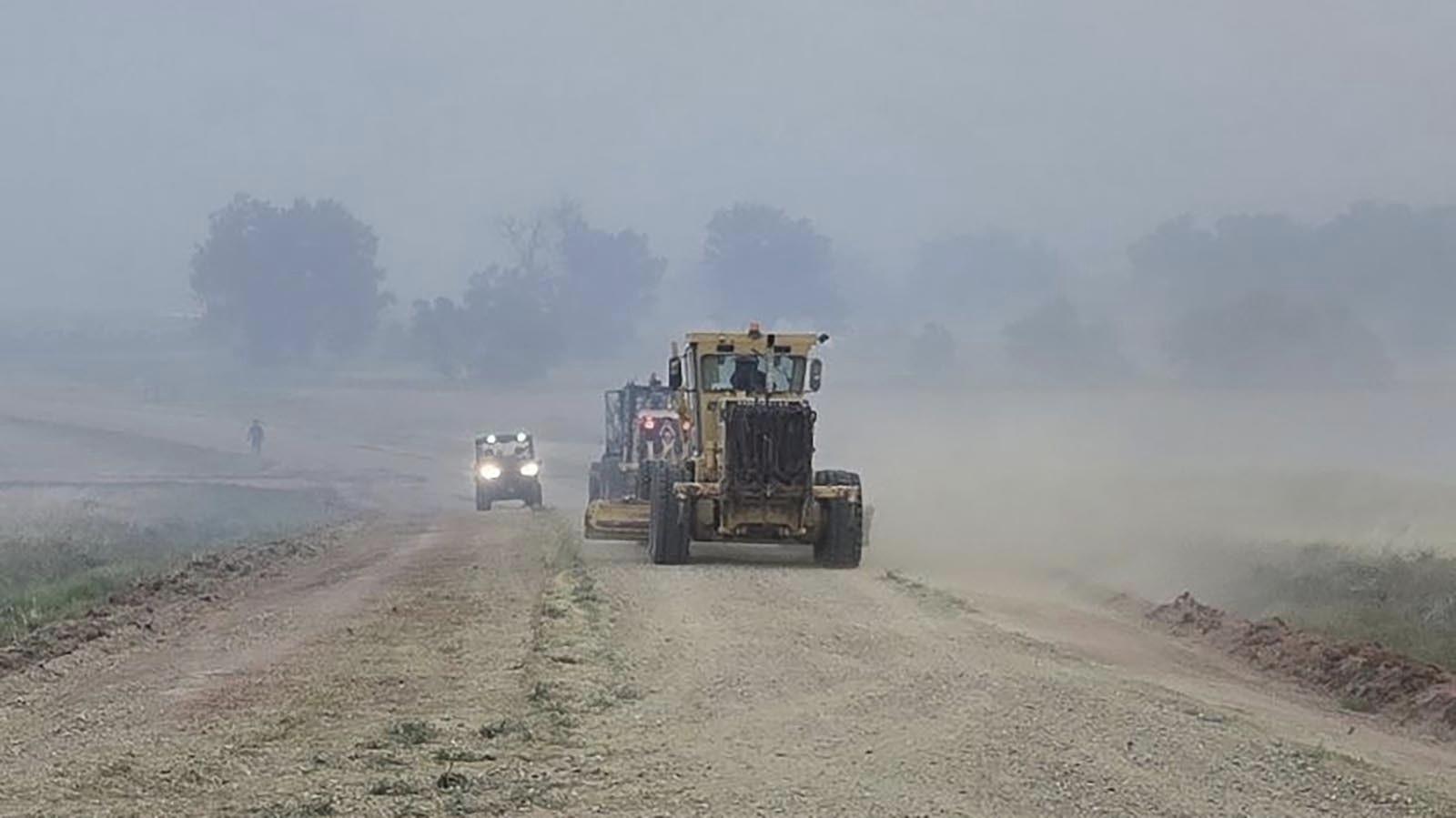 Heavy construction equipment is put into play fighting the House Draw Fire in northern Wyoming.