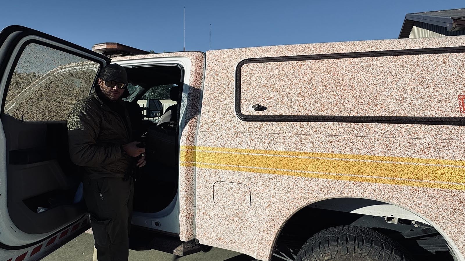 Isaac Bayer with the Bureau of Land Management, got his truck sprayed with red slurry on Thursday from a plane that dumped the product on the House Draw Fire to the east of Buffalo, Wyoming.