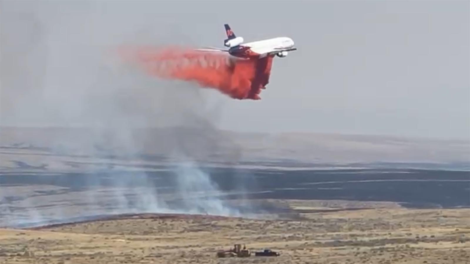 An aircraft drops mud on the House Draw Fire.