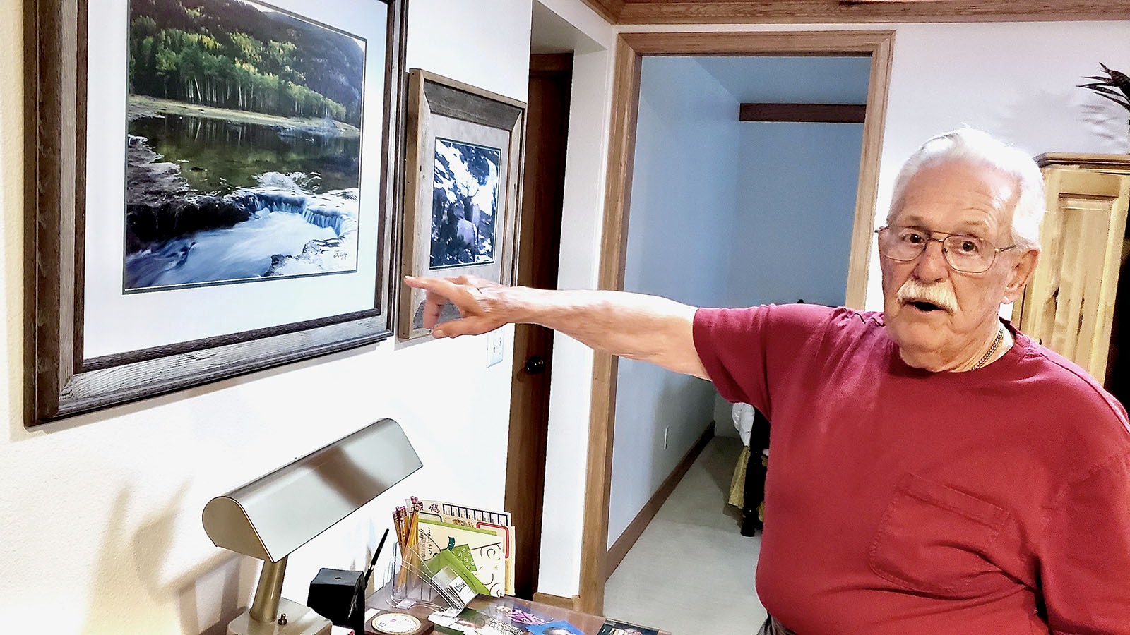 Howard Dykes points to a photo of the dam in Estes Park, Colorado, that failed in 1982. It was never rebuilt, so it's a photo that can never be duplicated.