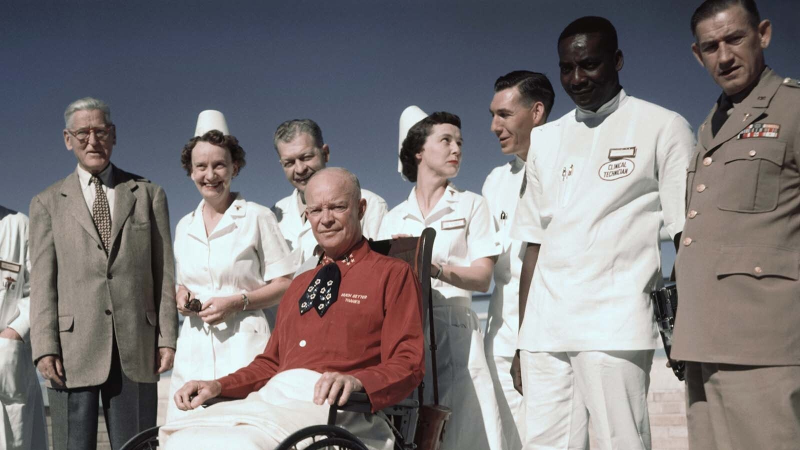 President Dwight Eisenhower at Fitzsimmnons Army Hospital in Colorado after suffering a heart attack. He's accompanied by his personal physician, far left, Dr. Howard Snyder.