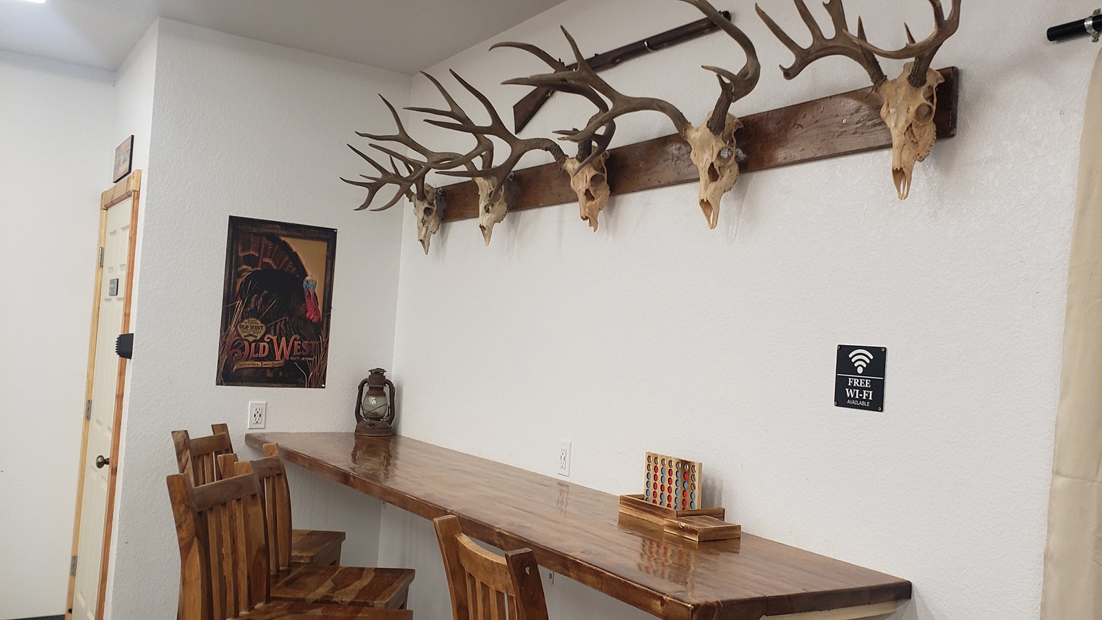 The table is made of wood Jake Barlow milled himself. He also made the rack with all the deer heads from animals he has hunted himself.