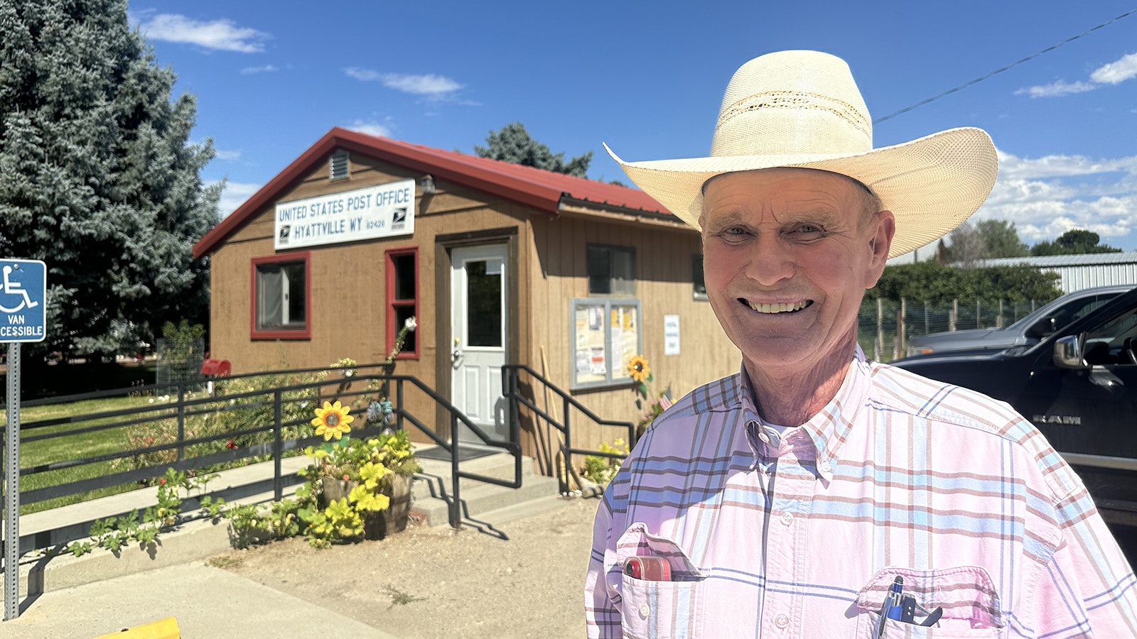 Rancher Bill Greer stands in front of the Hyattville Post Office, the last remaining business open to the public.