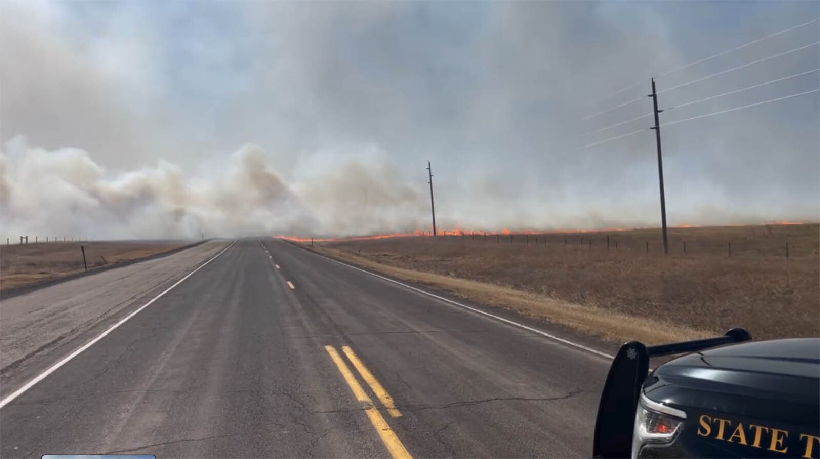 Flames from a fast-moving grass fire jumped Interstate 80 just west of Cheyenne on Saturday, driven by winds gusting more than 65 mph.