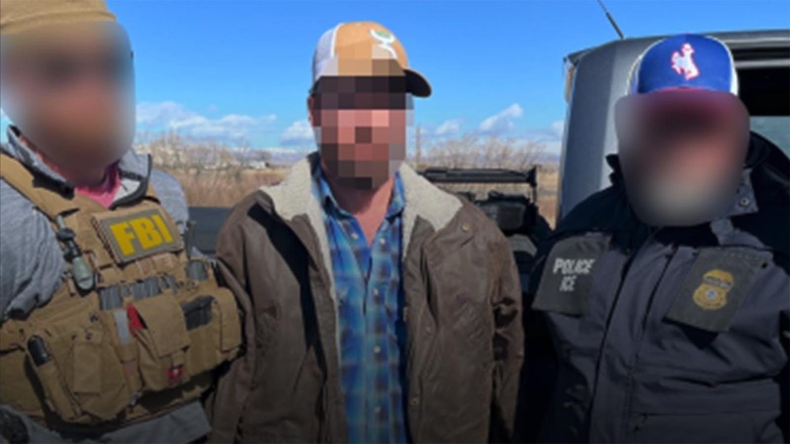 FBI agents Tuesday arrested an illegal immigrant they say has ties to a transnational drug cartel and is suspected of dealing large quantities of meth around Wyoming’s Wind River Indian Reservation. Two more people, including one illegal immigrant from Mexico, were also arrested. The FBI released this photo with the faces of agents and a suspect blurred out.