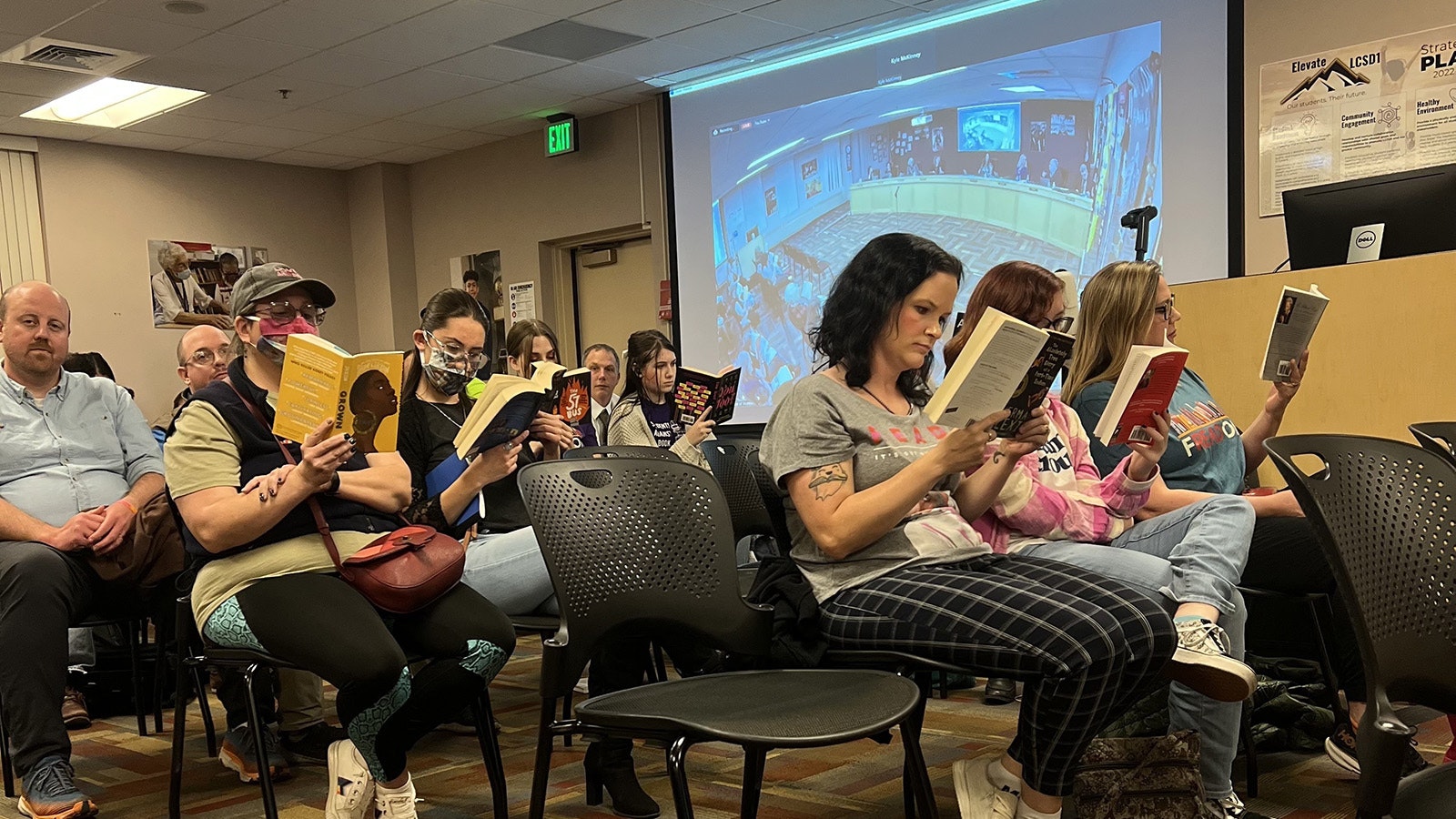 A group of parents and students staged a silent protest, reading controversial books during Monday's Laramie County School District board meeting.