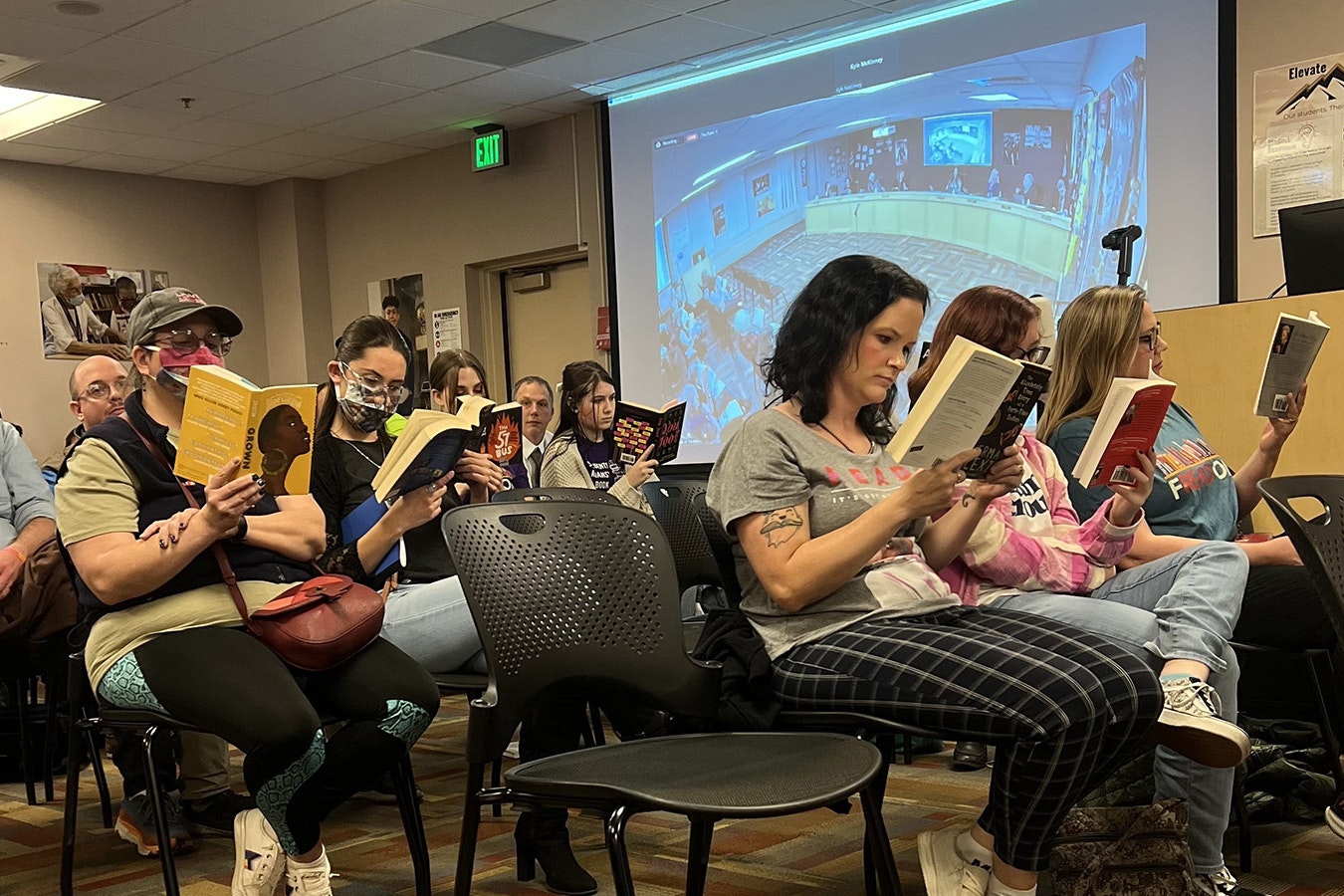 A group of parents and students staged a silent protest, reading controversial books during Monday's Laramie County School District board meeting.