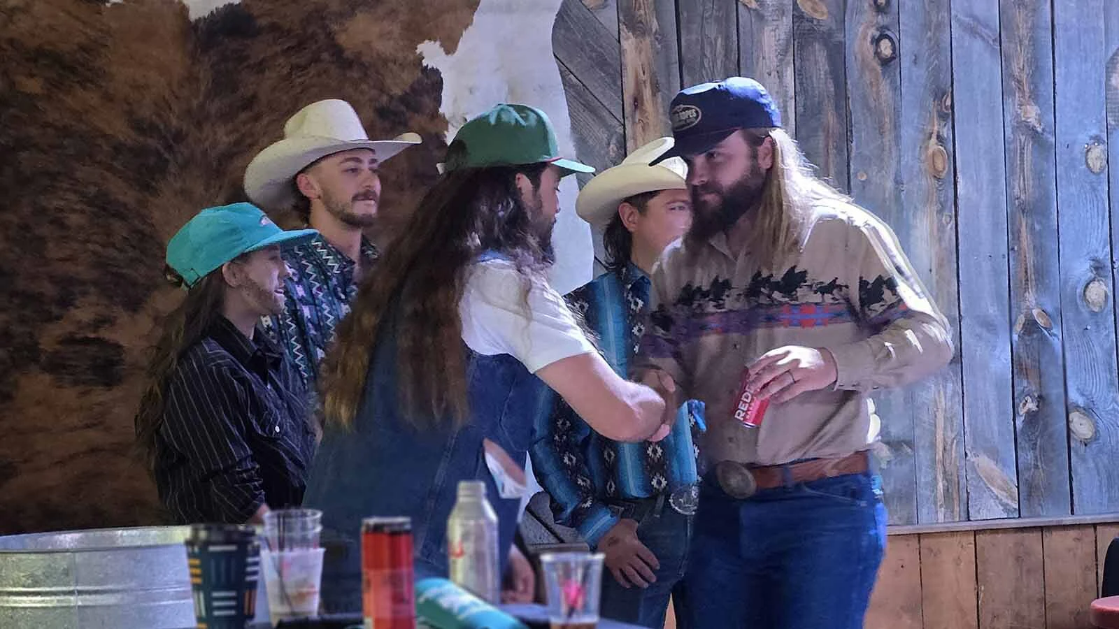 Ian Munsick shakes hands with a contestant in the Ian Munsick lookalike contest held at the Cowboy Saloon & Dance Hall in Laramie to promote Munsick's latest album.