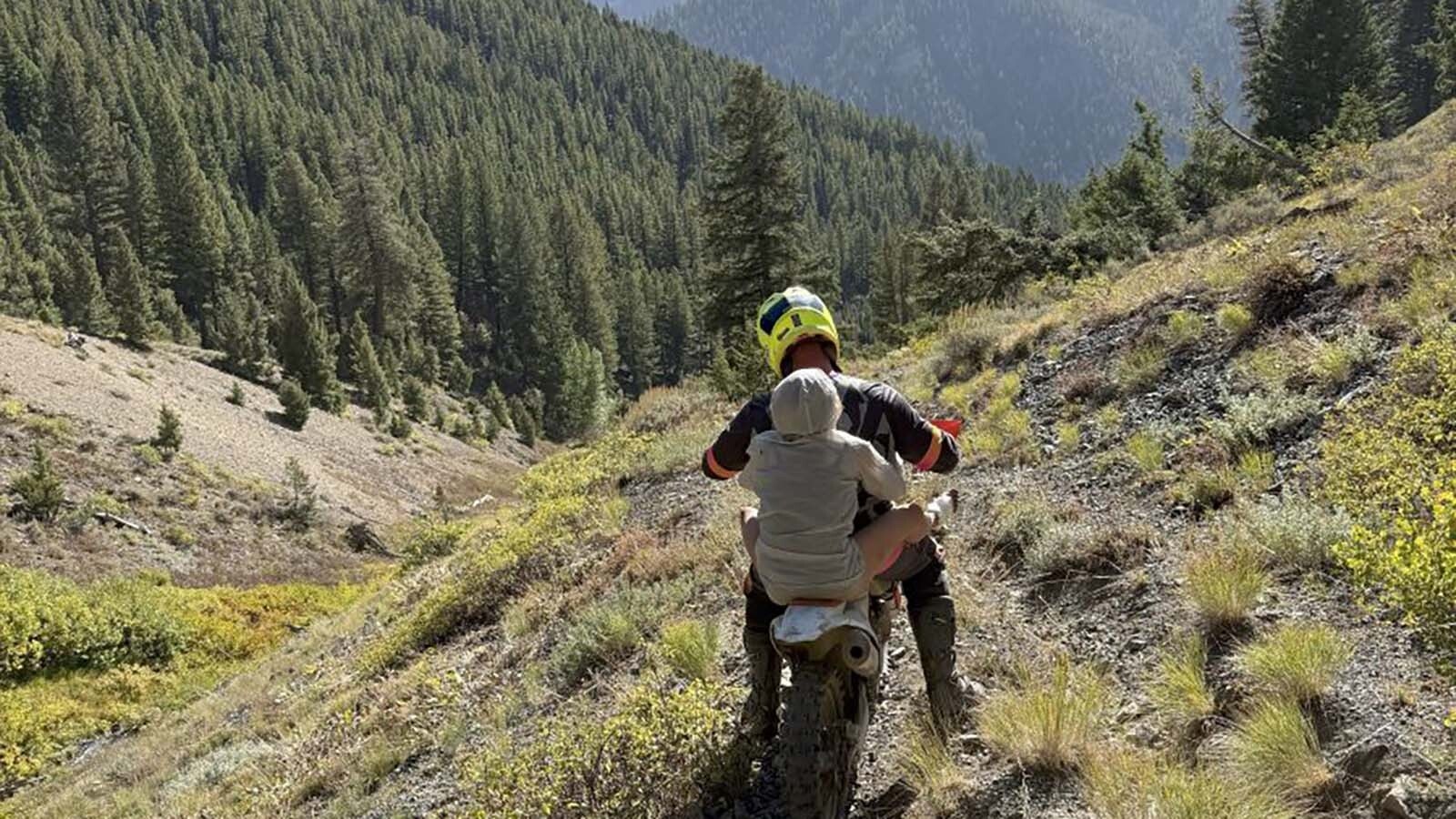Heather Wayment, 46, gets a ride on the back of a motorcycle to meadow big enough to land a rescue helicopter in the remote mountains of central Idaho on Sept. 18. After missing for two days in the wilderness, she was found by some mountain bikers who gave her food and water and sat with her until help arrived.