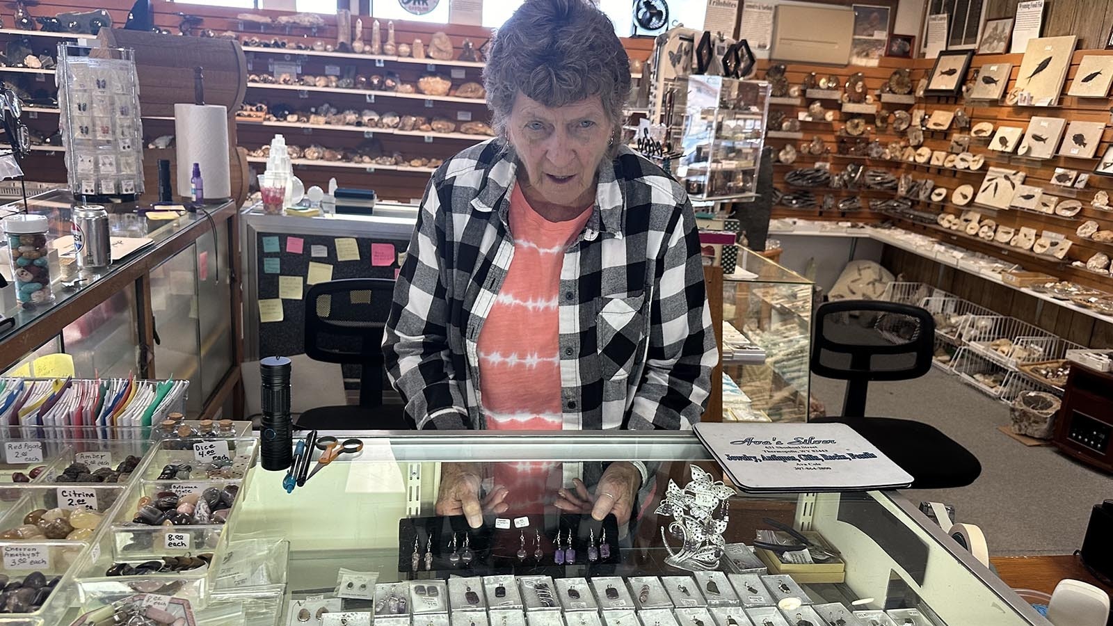 Ava Cole is surrounded by rocks of all types and her jewelry at Ava’s Silver and Rock Shop in Thermopolis, Wyoming.