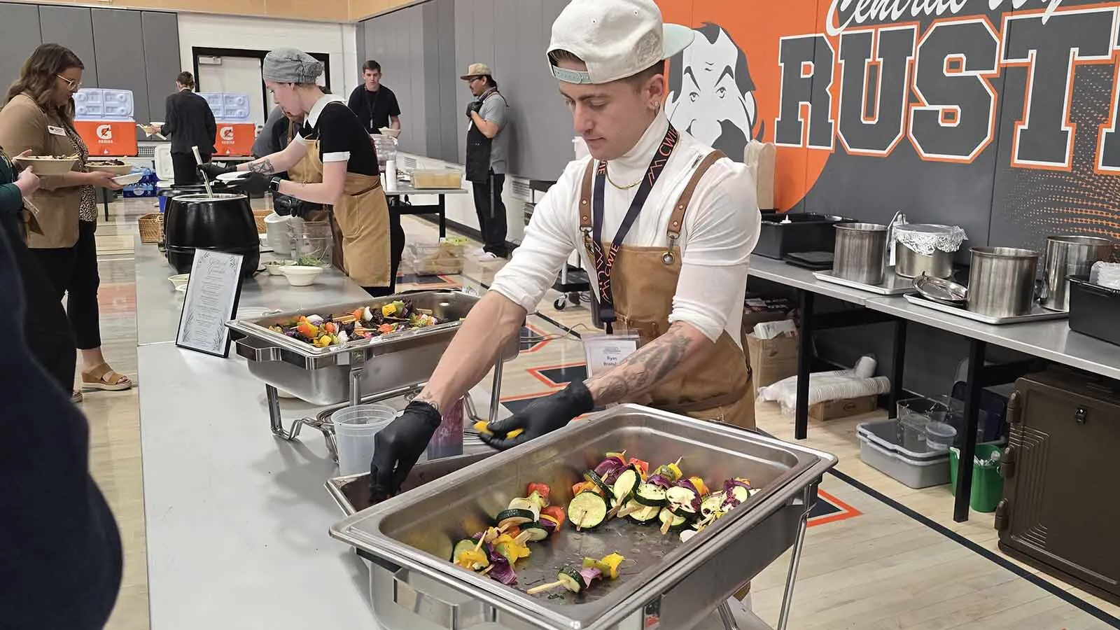 Central Wyoming Colleg culinary student Ryan Bradshaw sauces up a bison skewer with huckleberry sauce for an all-Indigenous lunch menu served during the 2026 Innovation & Entrepreneurship Conference.