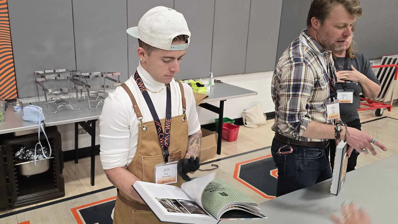 Central Wyoming Collegge culinary student Ryan Bradshaw flips through his copy of Chef Sean Sherman's latest cookbook, "Turtle Island," during he 2026 Innovation & Entrepreneurship Conference.
