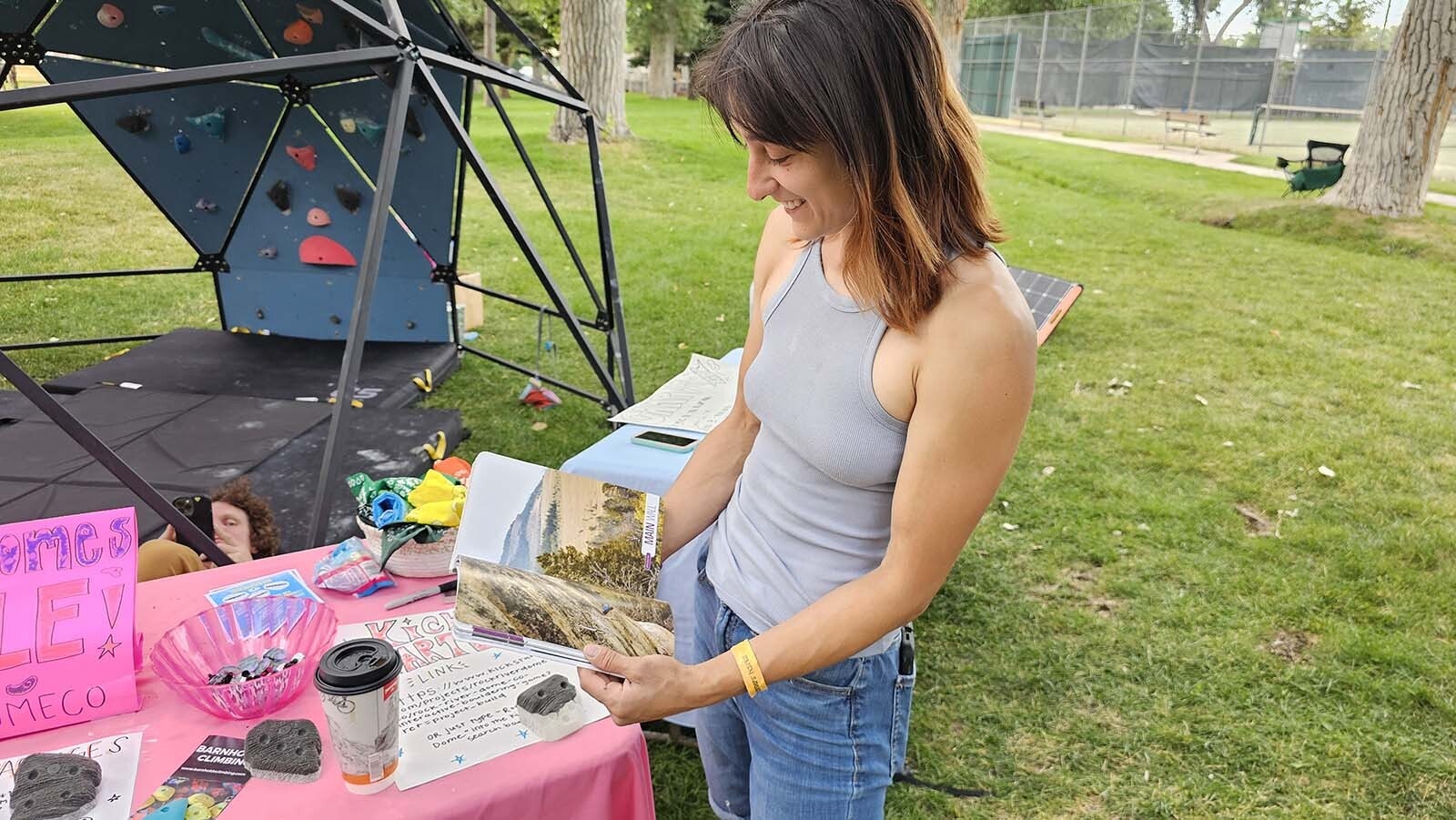 Marissa Murr pages through a book that has more than 1,000 sport limestone climbs in the Lander area. It's just one of dozens of climbing books on Lander that were available during the International Climbers' Festival in Lander.
